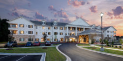 Photograph of sunset behind the main building of Grand Village at Clear Creek