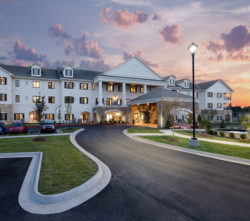 Photograph of sunset behind the main building of Grand Village at Clear Creek