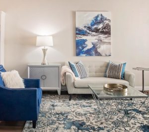 Photograph of beautiful living space with couch and artwork