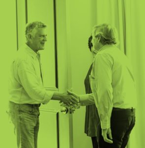 Photograph of two men shaking hands